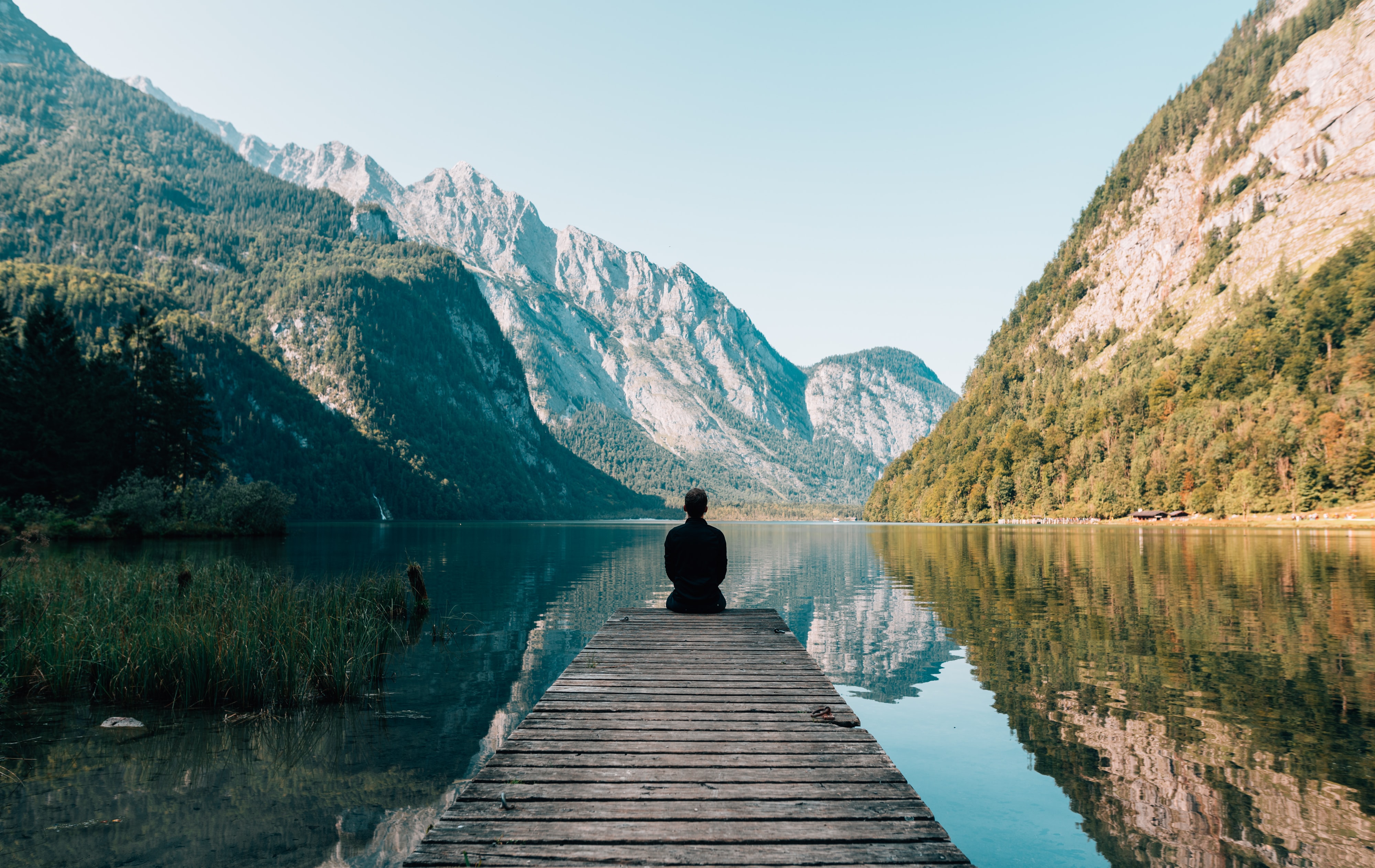 Figure by lake, surrounded by mountains. For an article about 